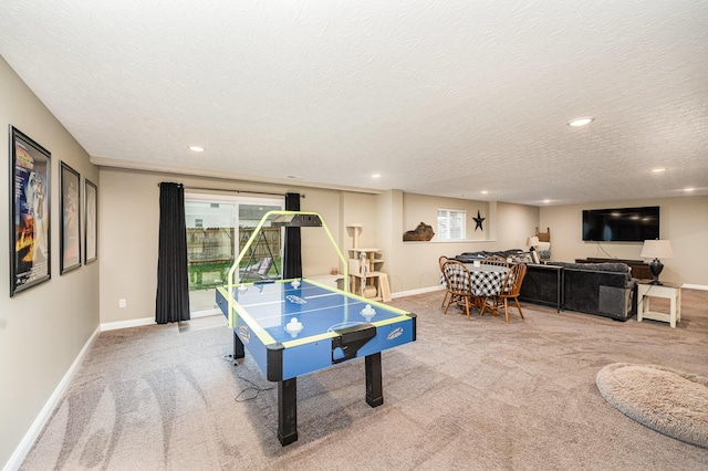 rec room featuring carpet flooring and a textured ceiling