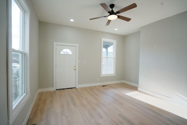 foyer with ceiling fan, light wood-type flooring, and a wealth of natural light