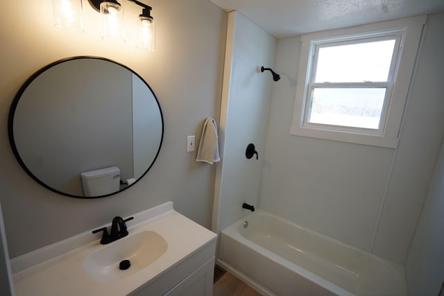 full bathroom with bathtub / shower combination, vanity, and toilet