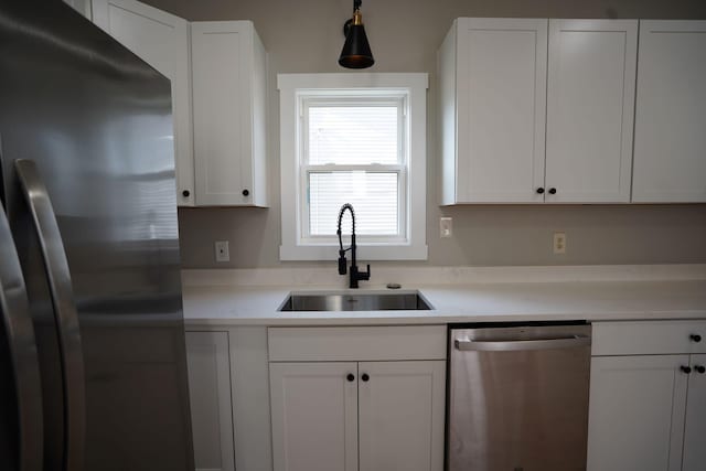 kitchen featuring sink, white cabinets, and stainless steel appliances