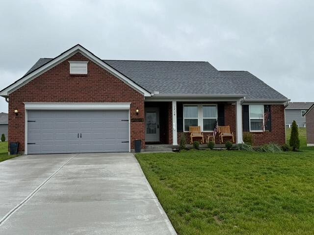 view of front facade with a garage and a front lawn