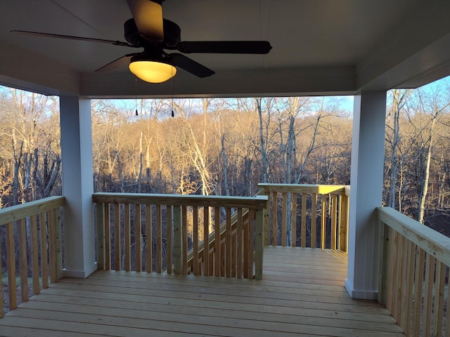 wooden deck featuring ceiling fan