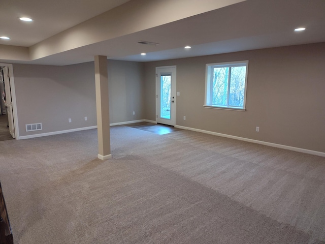 below grade area featuring carpet, visible vents, and recessed lighting