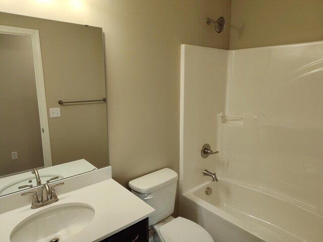 full bathroom featuring toilet, washtub / shower combination, and vanity