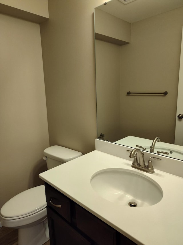 bathroom featuring toilet and vanity