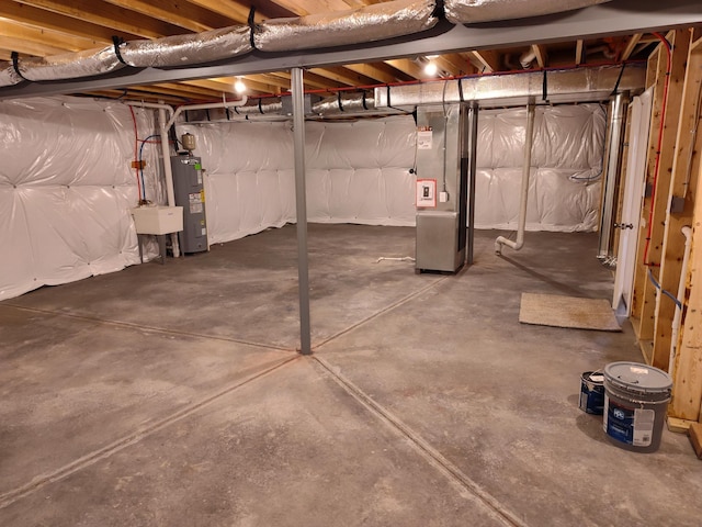 unfinished below grade area featuring water heater and a sink