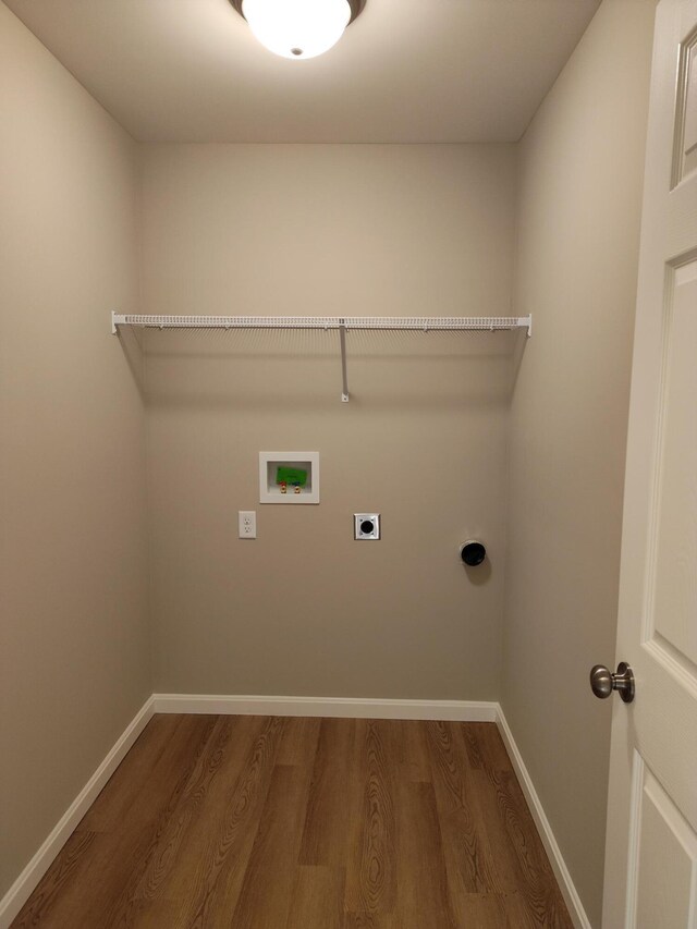 clothes washing area featuring washer hookup, dark wood-style flooring, electric dryer hookup, laundry area, and baseboards