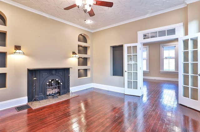 unfurnished living room featuring french doors, ornamental molding, built in features, and dark hardwood / wood-style floors