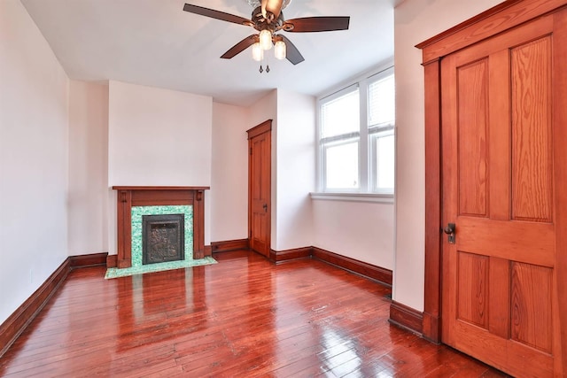 unfurnished living room with ceiling fan and hardwood / wood-style floors