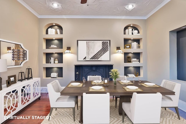 dining area featuring hardwood / wood-style floors, ornamental molding, and built in features