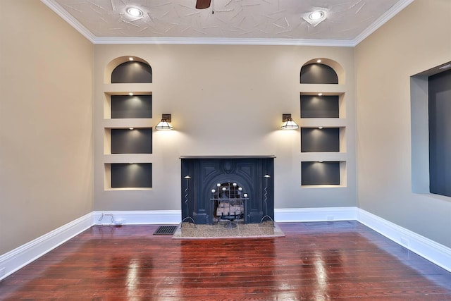 unfurnished living room featuring built in features, crown molding, and wood-type flooring