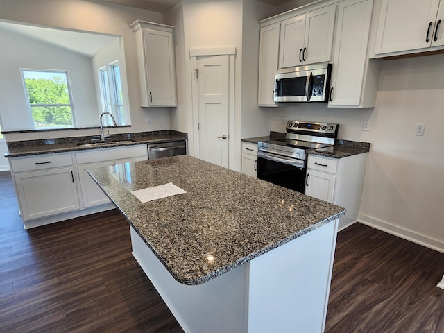 6566 Cannondale Dr, Burlington, KY 41005 - kitchen with appliances with stainless steel finishes, a sink, dark wood-style floors, baseboards, and dark stone countertops