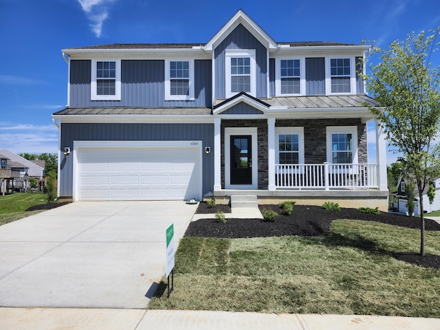 6566 Cannondale Dr, Burlington, KY 41005 - view of front facade with a standing seam roof, metal roof, driveway, an attached garage, and covered porch
