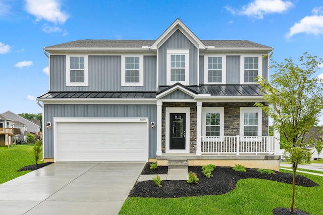 6566 Cannondale Dr, Burlington, KY 41005 - view of front of home with a standing seam roof, a porch, concrete driveway, board and batten siding, and an attached garage