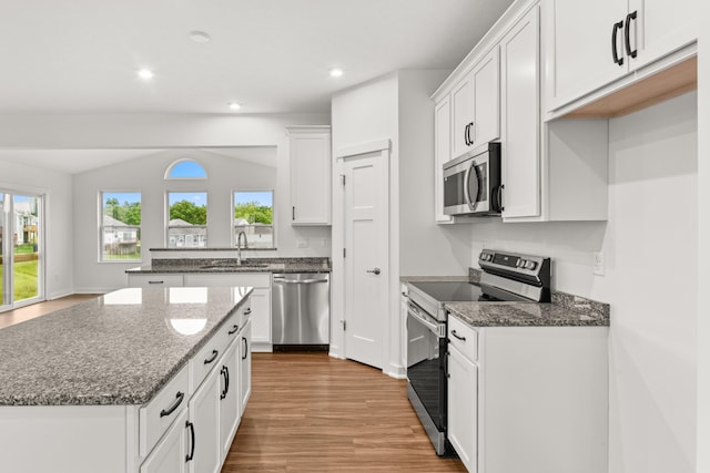 6566 Cannondale Dr, Burlington, KY 41005 - kitchen featuring stainless steel appliances, light wood-type flooring, white cabinetry, dark stone countertops, and recessed lighting