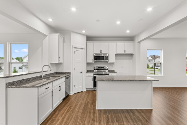 6566 Cannondale Dr, Burlington, KY 41005 - kitchen with stainless steel appliances, dark wood-type flooring, a sink, white cabinetry, and dark stone countertops