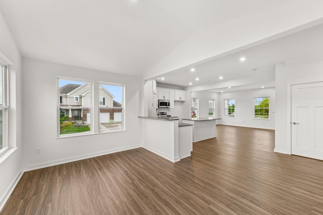 6566 Cannondale Dr, Burlington, KY 41005 - kitchen with appliances with stainless steel finishes, open floor plan, dark wood-style floors, white cabinetry, and vaulted ceiling
