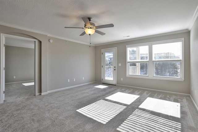 carpeted empty room with crown molding and ceiling fan