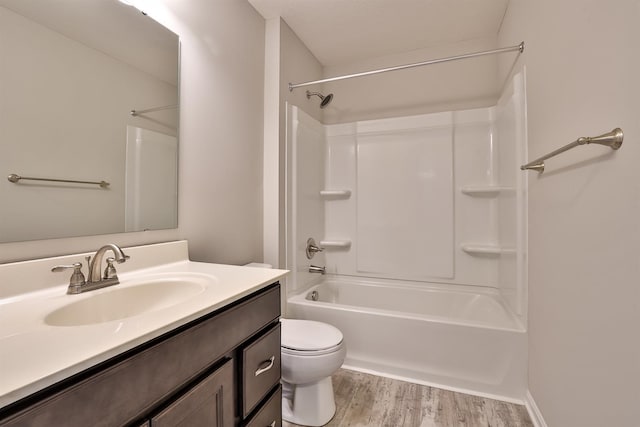 full bathroom featuring vanity, hardwood / wood-style floors, bathing tub / shower combination, and toilet