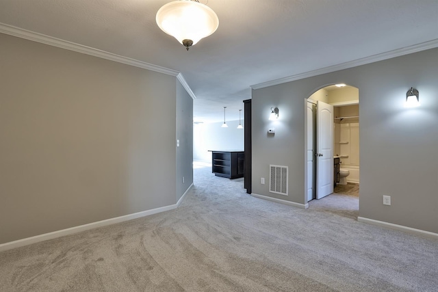 carpeted spare room featuring ornamental molding