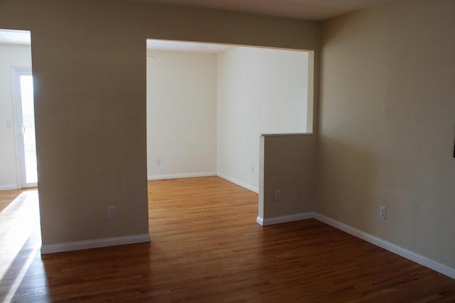 spare room featuring dark wood-type flooring