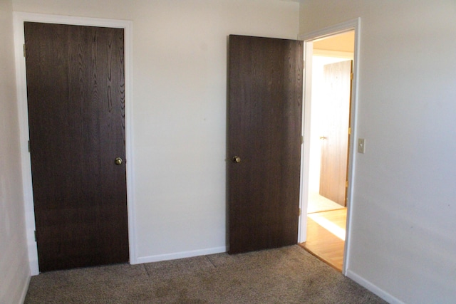 unfurnished bedroom featuring carpet flooring and a closet