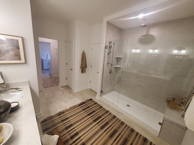 bathroom with vanity, a shower with shower door, and hardwood / wood-style flooring