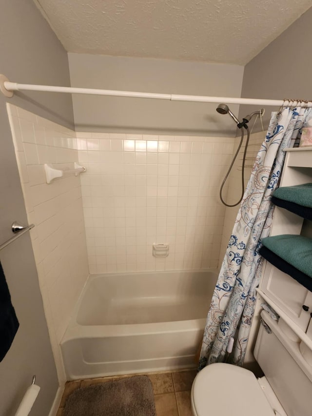 bathroom featuring tile patterned flooring, shower / bath combo, a textured ceiling, and toilet