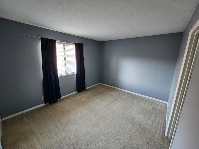 carpeted spare room featuring a textured ceiling