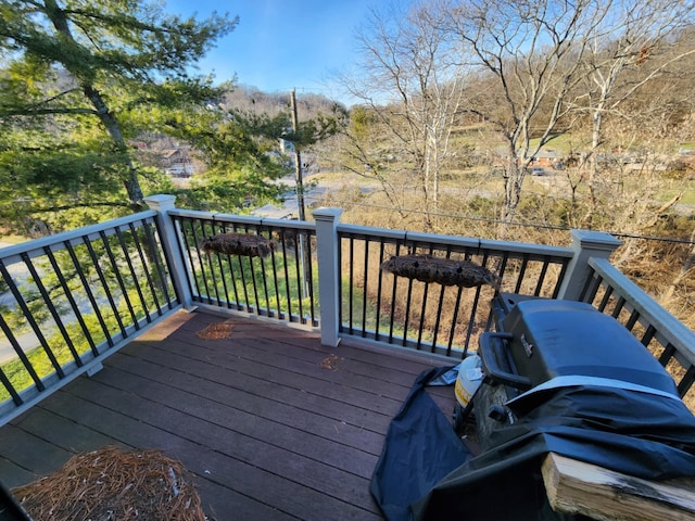 wooden deck with a grill