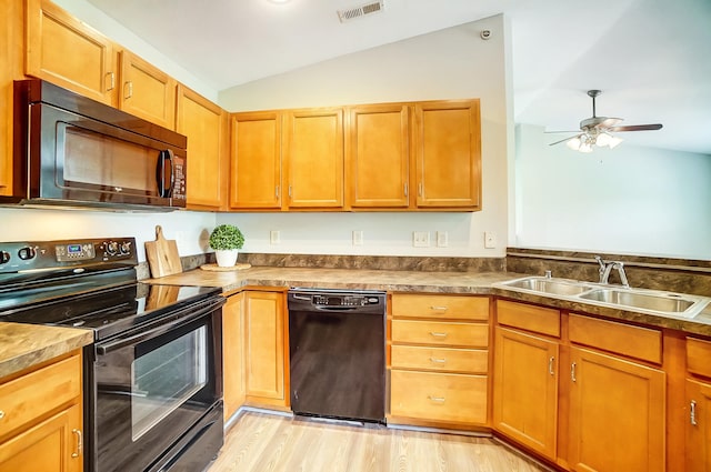 kitchen featuring ceiling fan, sink, vaulted ceiling, black appliances, and light wood-type flooring