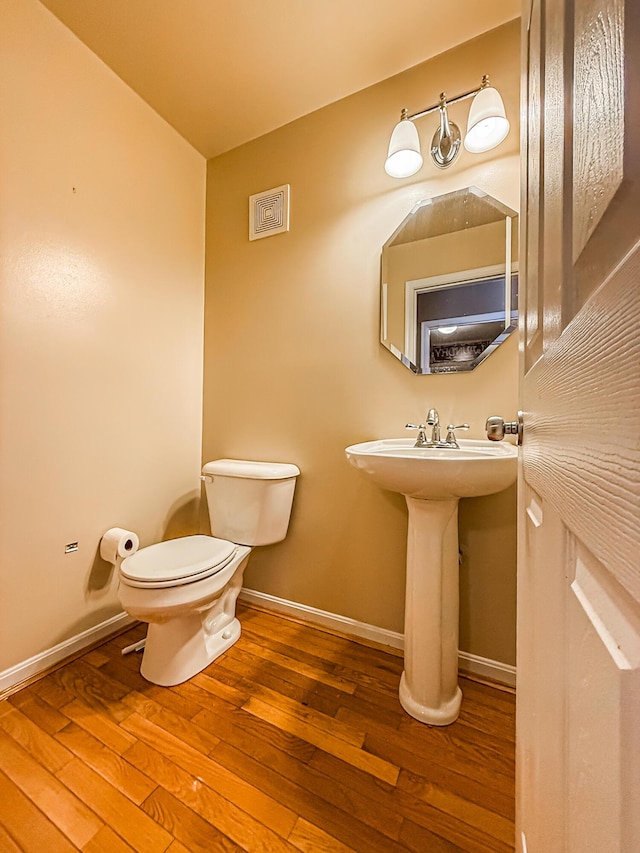 bathroom featuring toilet and hardwood / wood-style floors