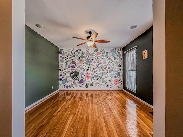 unfurnished room with ceiling fan and hardwood / wood-style floors