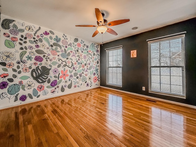 spare room featuring light hardwood / wood-style floors and ceiling fan