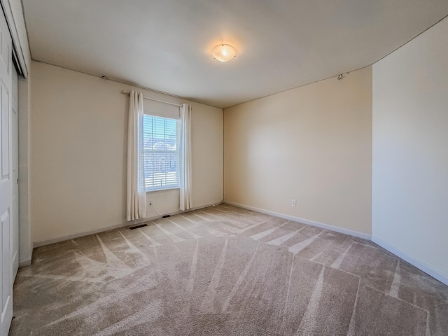 empty room featuring light colored carpet