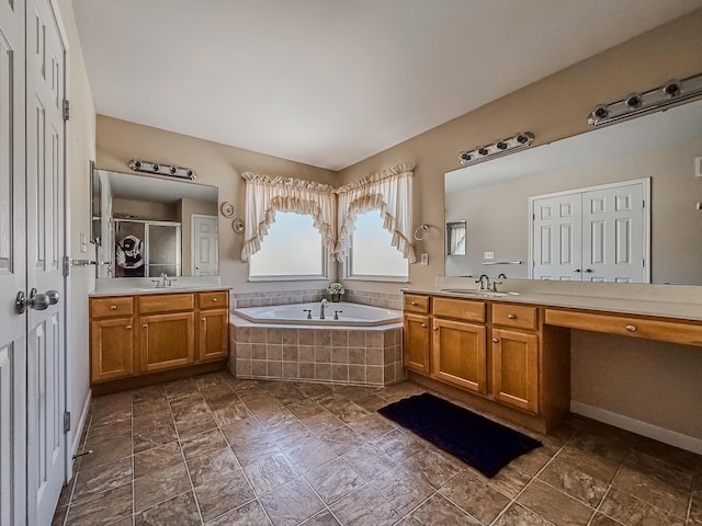 bathroom featuring shower with separate bathtub and vanity