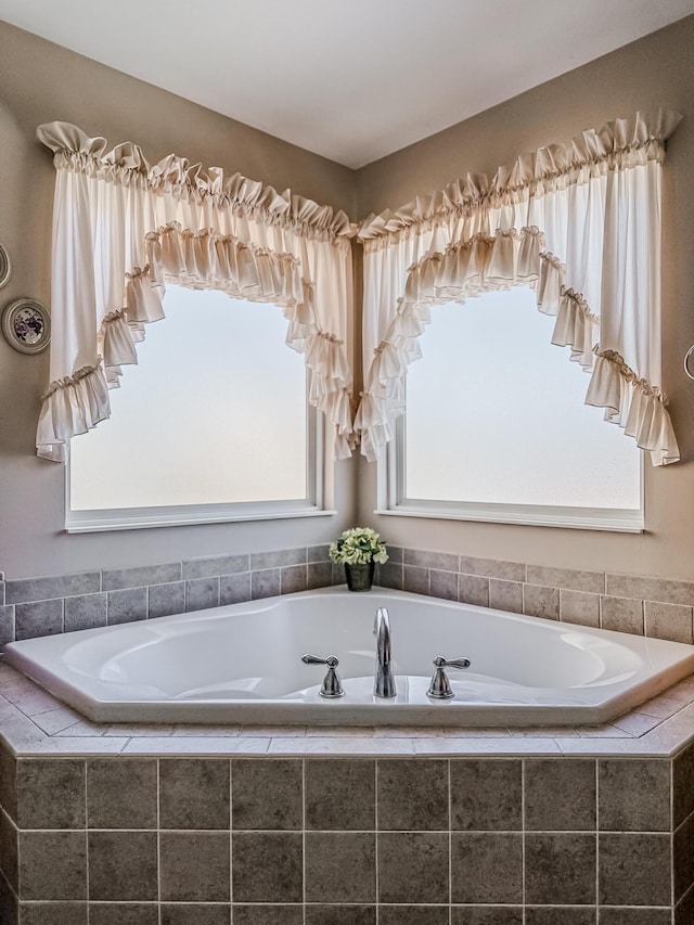 bathroom featuring tiled tub