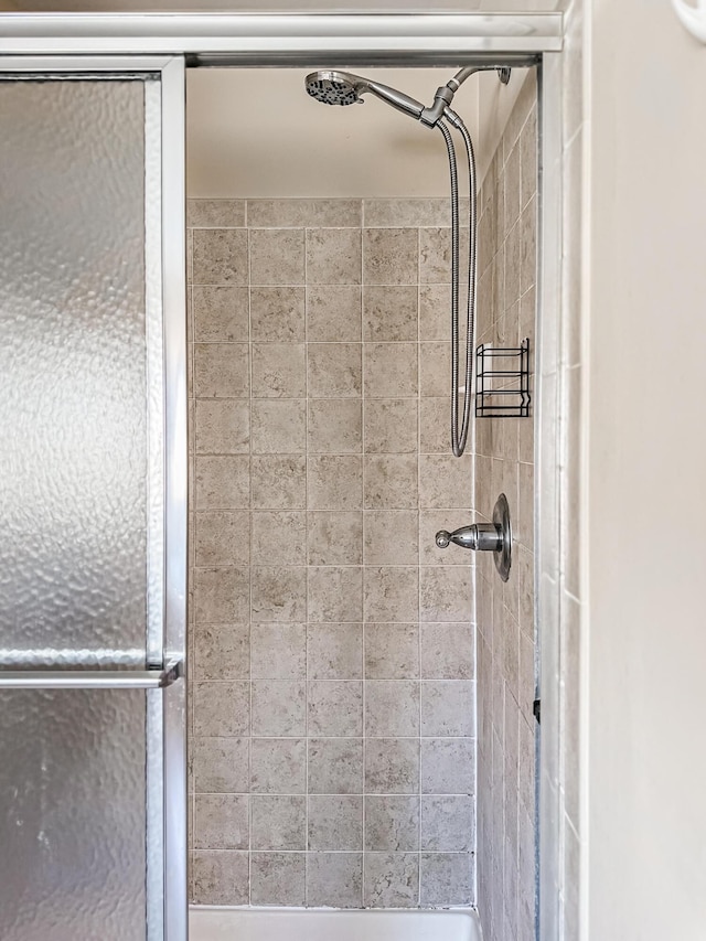 bathroom with a tile shower