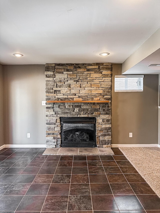 interior details with a stone fireplace