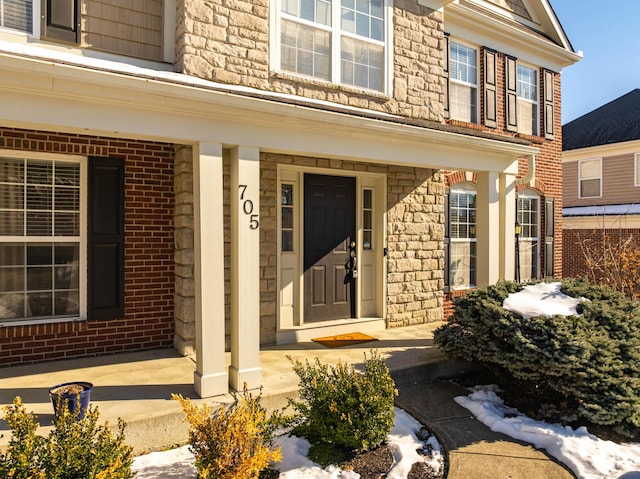 entrance to property featuring a porch