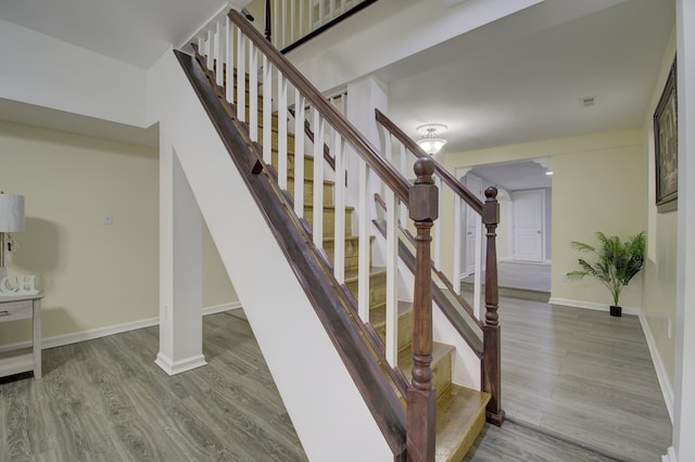 stairway featuring hardwood / wood-style flooring