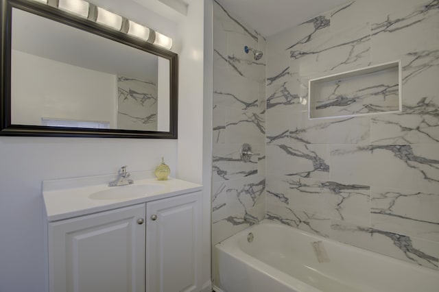 bathroom featuring vanity and tiled shower / bath