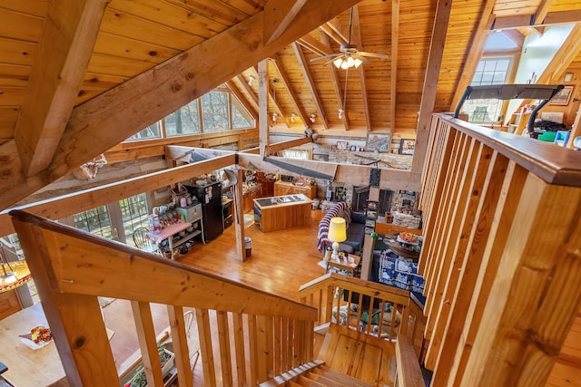 staircase with vaulted ceiling with beams, wood ceiling, ceiling fan, and wood finished floors