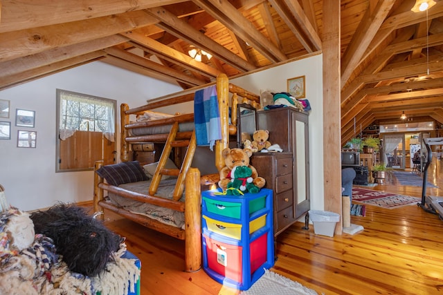 bedroom featuring wooden ceiling, lofted ceiling with beams, and hardwood / wood-style flooring