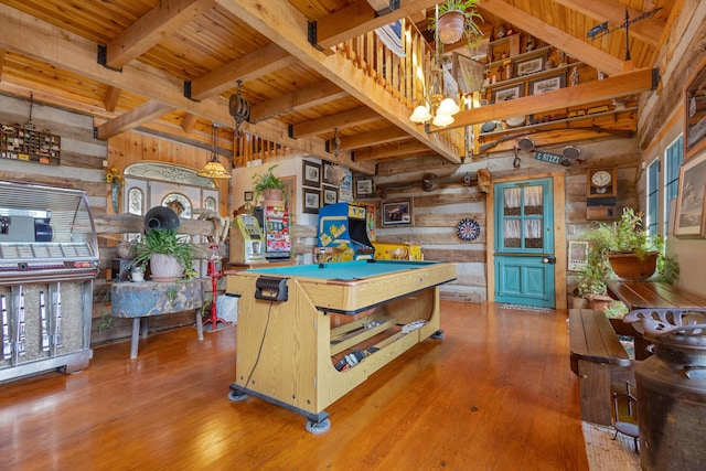 interior space featuring wooden ceiling, beamed ceiling, wooden walls, and wood finished floors