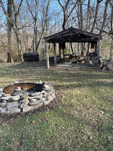 view of yard with an outdoor fire pit and a gazebo