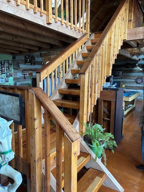 stairway featuring wood finished floors