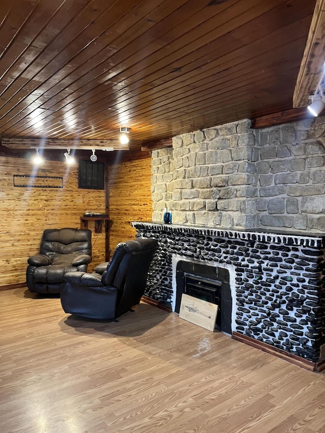 interior space featuring wooden walls, hardwood / wood-style floors, and wood ceiling