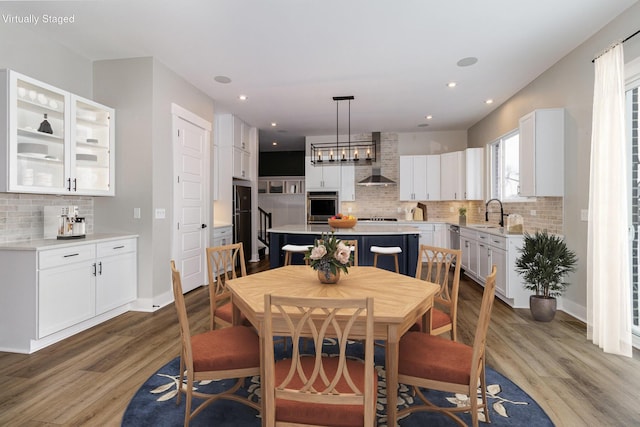 dining space featuring sink and wood-type flooring