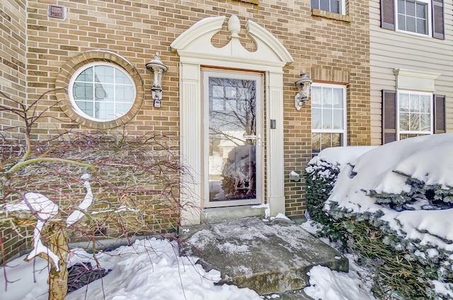 view of snow covered property entrance